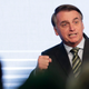 Brazilian President Jair Bolsonaro speaking to a steel industry meeting, where he falsely claimed NGOs are burning down the Amazon in retaliation for budget cuts, on Wednesday.